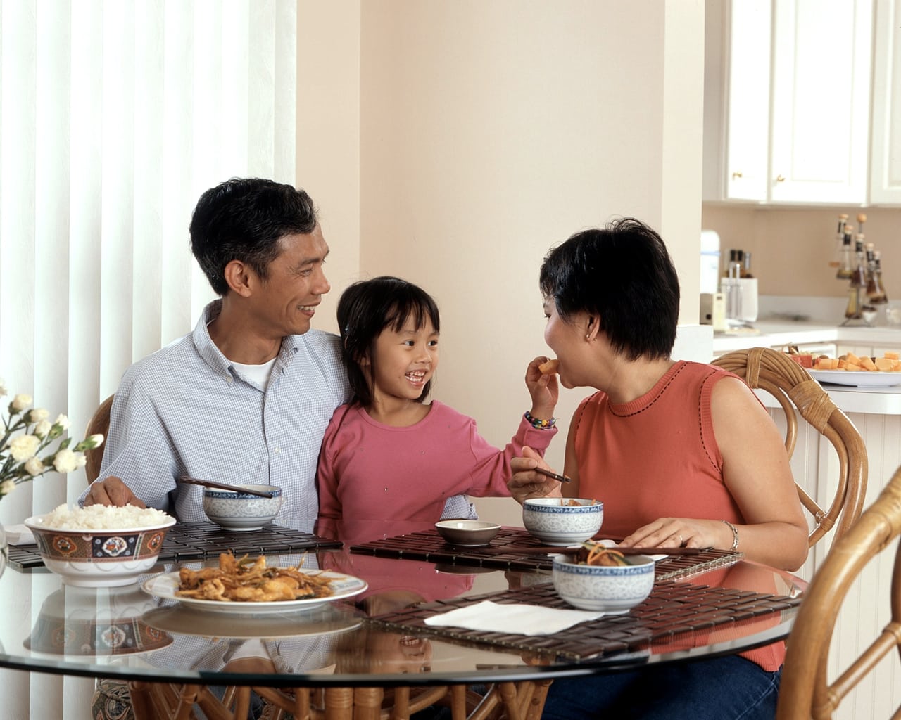 Détail d'une table familiale dressée pour le repas, ambiance chaleureuse.